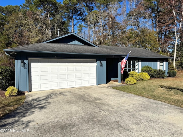 ranch-style home with a garage and a front lawn