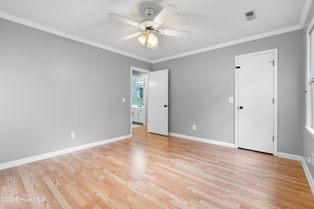 spare room featuring light hardwood / wood-style floors, ornamental molding, and ceiling fan