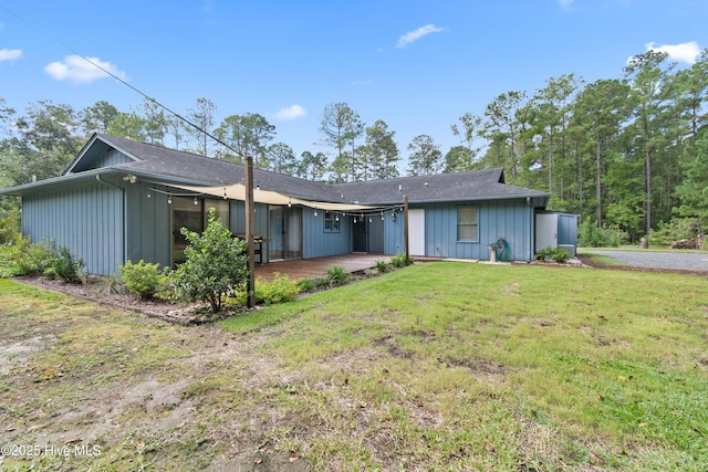 view of front of property with a patio and a front yard