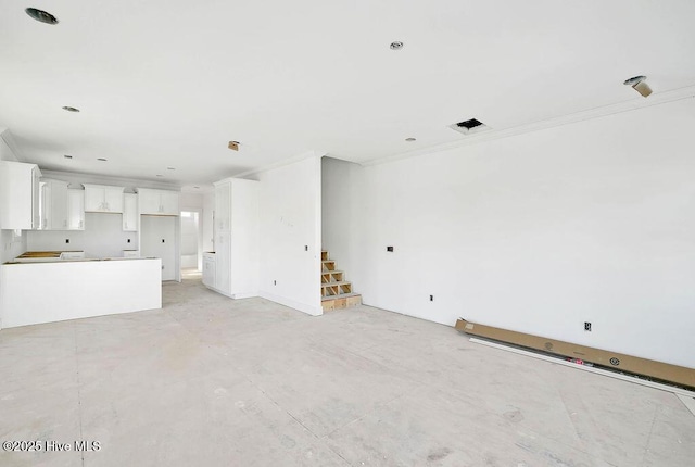 unfurnished living room featuring ornamental molding