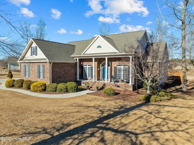 view of front of house featuring covered porch and a front lawn