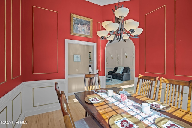 dining area featuring light hardwood / wood-style floors and a chandelier