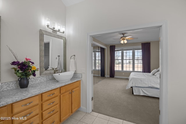 bathroom featuring baseboards, a ceiling fan, vanity, and tile patterned flooring