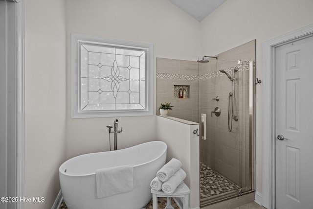 bathroom with a shower stall and a soaking tub
