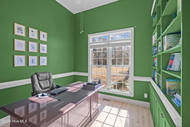 office area with crown molding and light hardwood / wood-style flooring