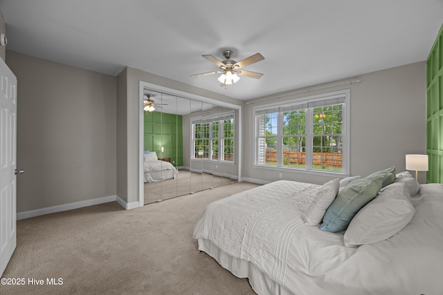 carpeted bedroom with baseboards and a ceiling fan