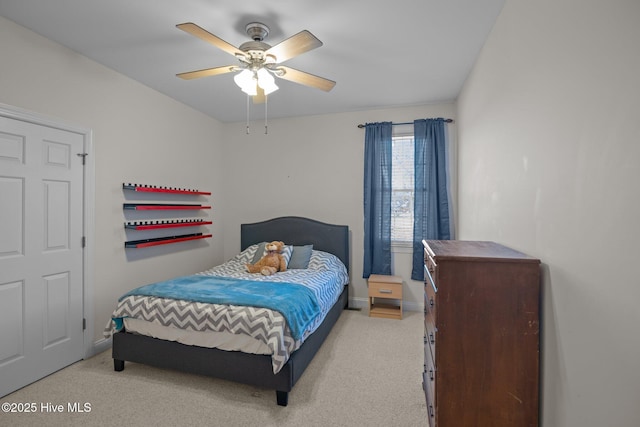 bedroom featuring light colored carpet, ceiling fan, and baseboards