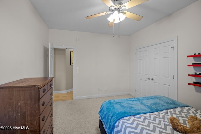 bedroom featuring ceiling fan, light carpet, and baseboards