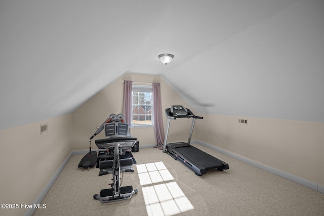 exercise area with visible vents, vaulted ceiling, light carpet, and baseboards