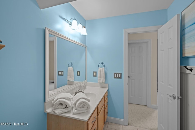 bathroom with baseboards, vanity, and tile patterned floors