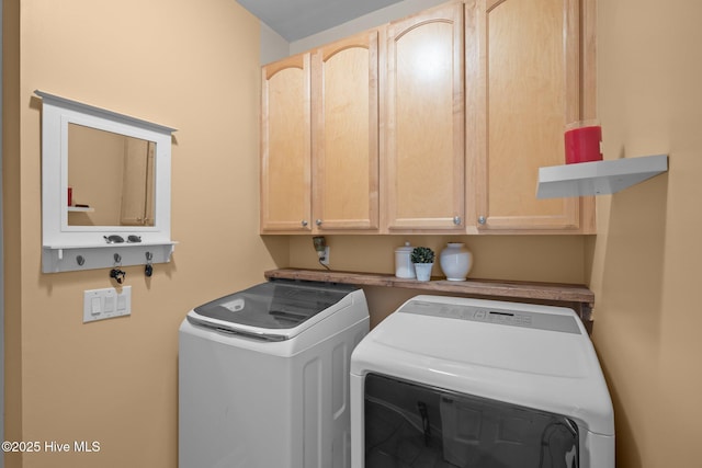 laundry area featuring cabinets and independent washer and dryer