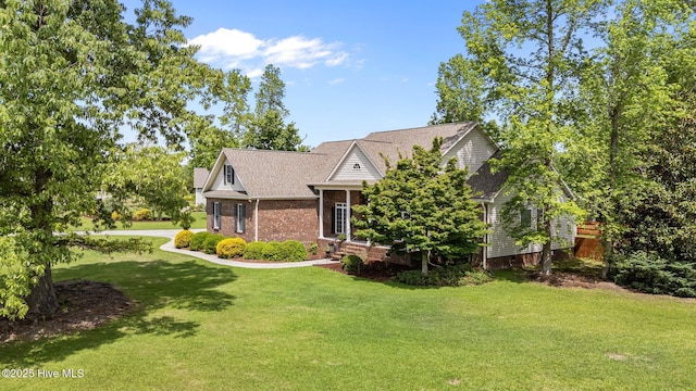 view of front of house featuring a front yard and brick siding
