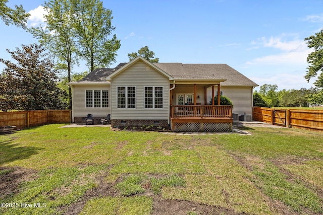 rear view of property featuring a wooden deck, a fenced backyard, a yard, and crawl space