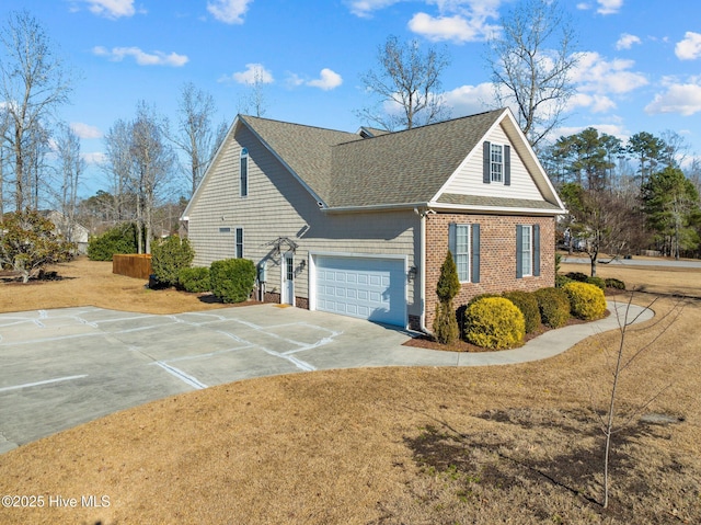 view of side of property with a yard and a garage