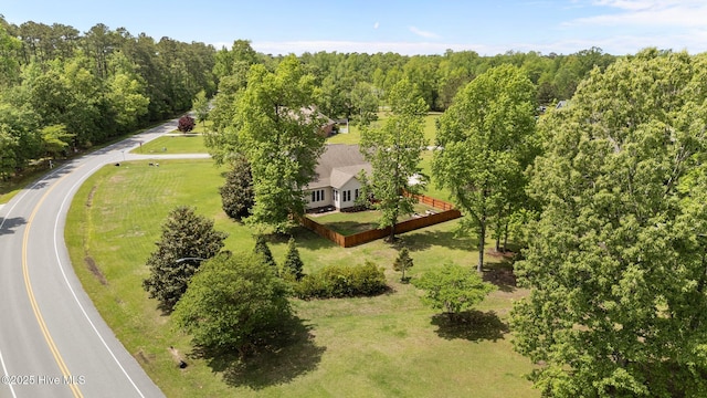drone / aerial view featuring a wooded view