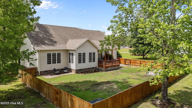 back of house featuring a wooden deck, roof with shingles, crawl space, a yard, and a fenced backyard