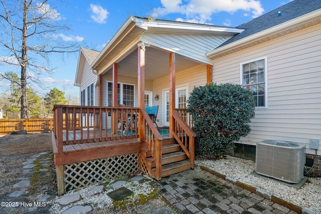 doorway to property with a wooden deck and cooling unit