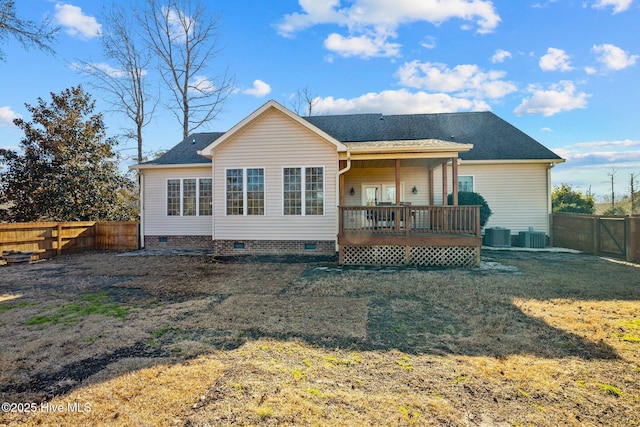 rear view of house with central AC, a yard, and a deck