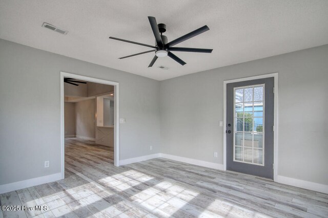 unfurnished room with light hardwood / wood-style flooring and ceiling fan