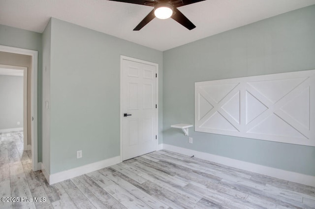 empty room featuring ceiling fan and light wood-type flooring