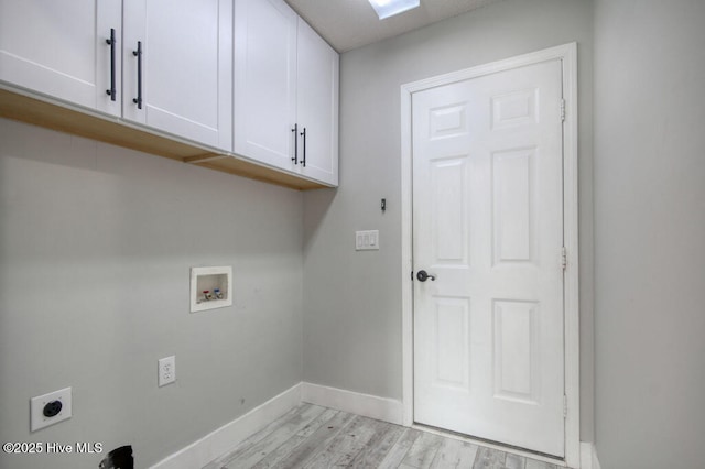 clothes washing area with cabinets, washer hookup, hookup for an electric dryer, and light hardwood / wood-style floors