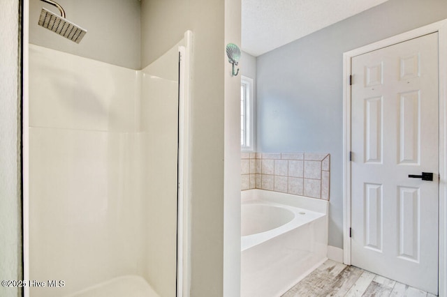 bathroom featuring hardwood / wood-style flooring and separate shower and tub