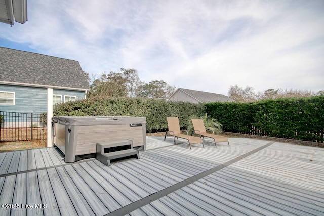 wooden deck featuring a hot tub