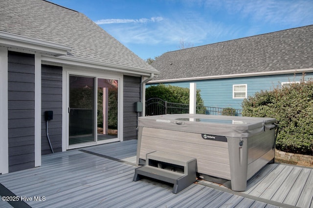 wooden deck with a hot tub