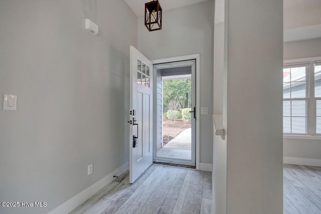 doorway featuring a wealth of natural light and light hardwood / wood-style flooring