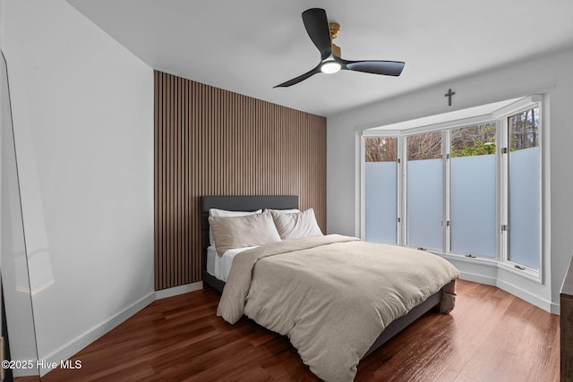 bedroom with dark hardwood / wood-style flooring and ceiling fan