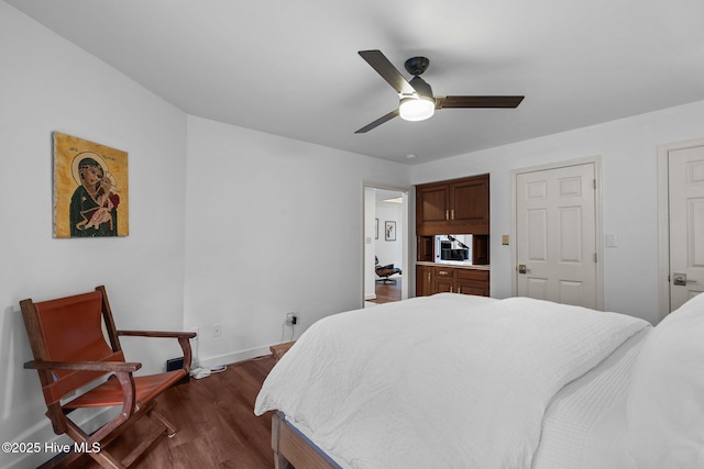 bedroom with dark hardwood / wood-style flooring and ceiling fan