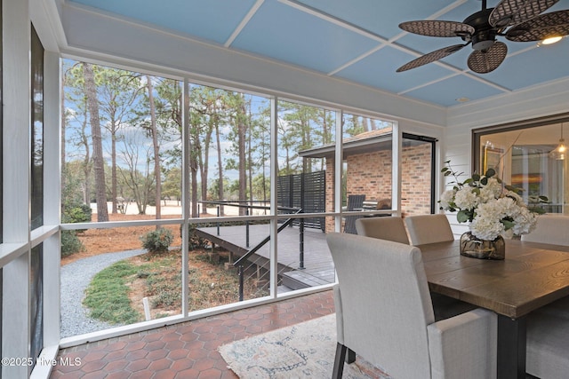 sunroom / solarium featuring ceiling fan