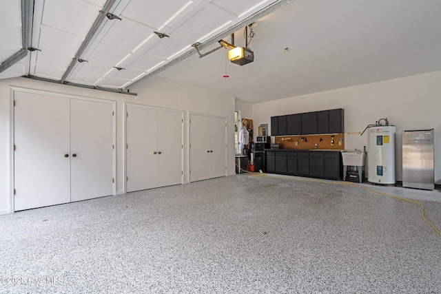 garage with a garage door opener, sink, and electric water heater