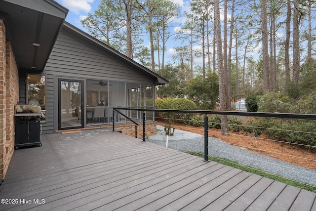 deck with a grill, a sunroom, and ceiling fan