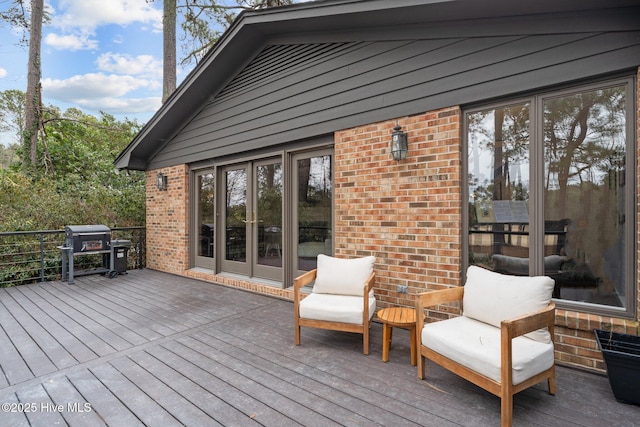 wooden terrace with a grill