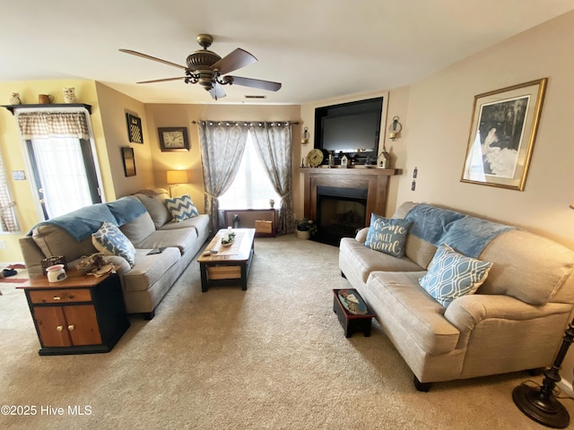 carpeted living room with ceiling fan