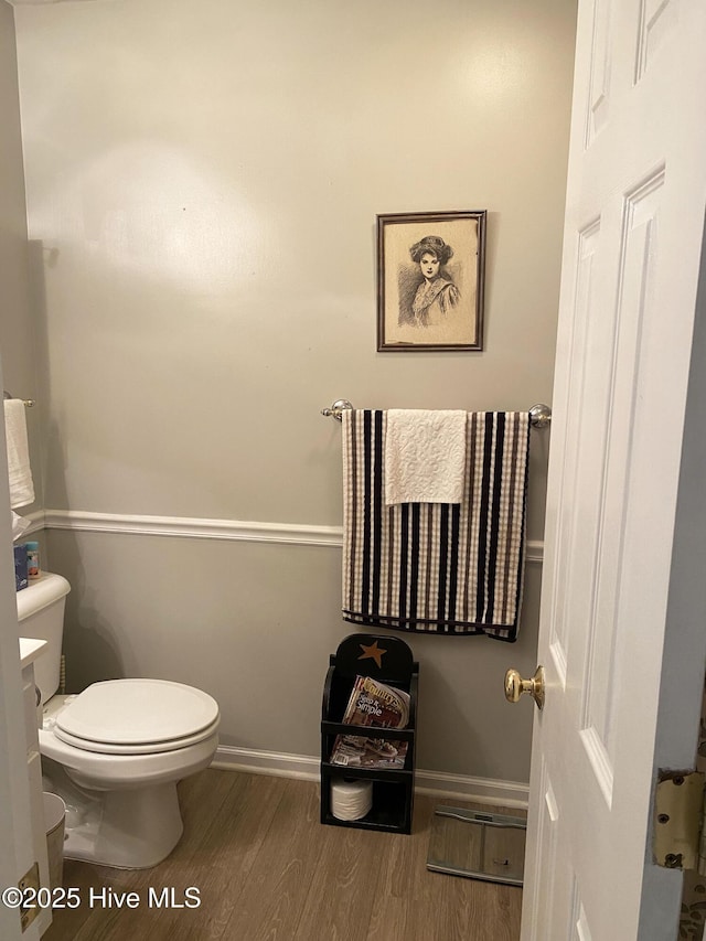 bathroom with hardwood / wood-style floors and toilet