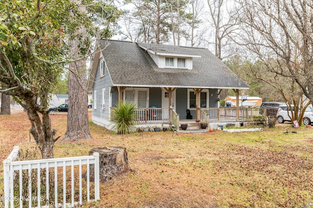 bungalow featuring a porch and a front lawn