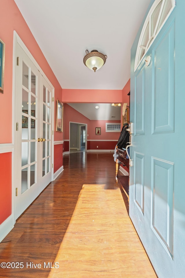 foyer entrance with french doors and hardwood / wood-style floors