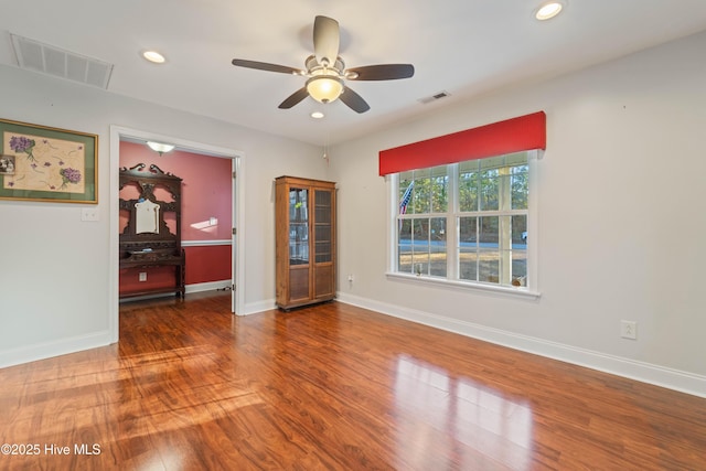 unfurnished room with ceiling fan and wood-type flooring