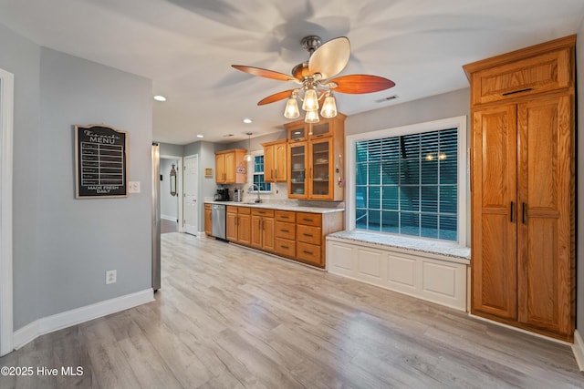 kitchen with sink, light wood-type flooring, dishwasher, and ceiling fan