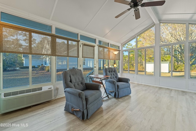 sunroom featuring ceiling fan, an AC wall unit, and vaulted ceiling with beams