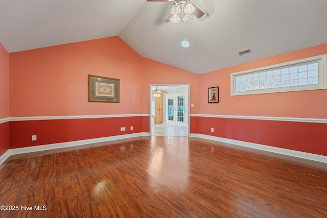 spare room featuring ceiling fan, vaulted ceiling, and wood-type flooring