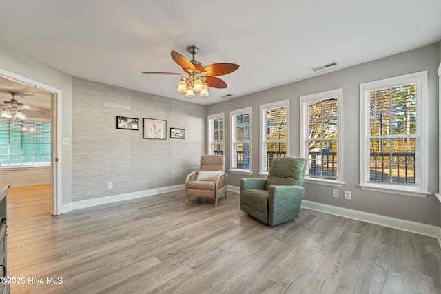 sitting room with light hardwood / wood-style flooring and ceiling fan