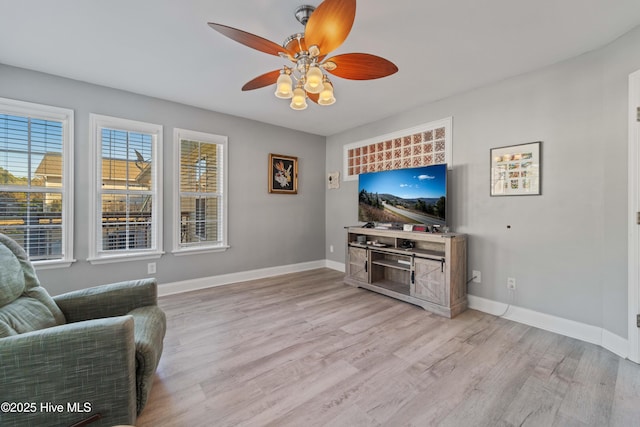 living room featuring ceiling fan and light hardwood / wood-style floors