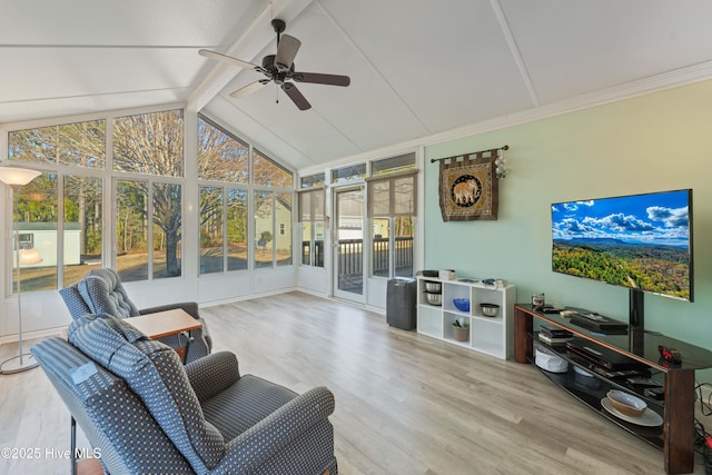 sunroom featuring lofted ceiling with beams and ceiling fan