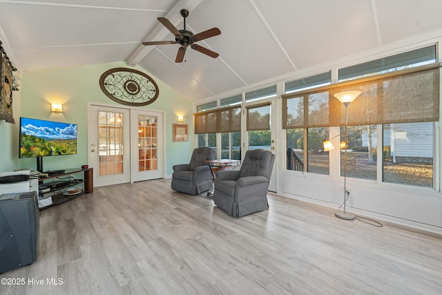 sunroom featuring ceiling fan, french doors, a healthy amount of sunlight, and lofted ceiling with beams