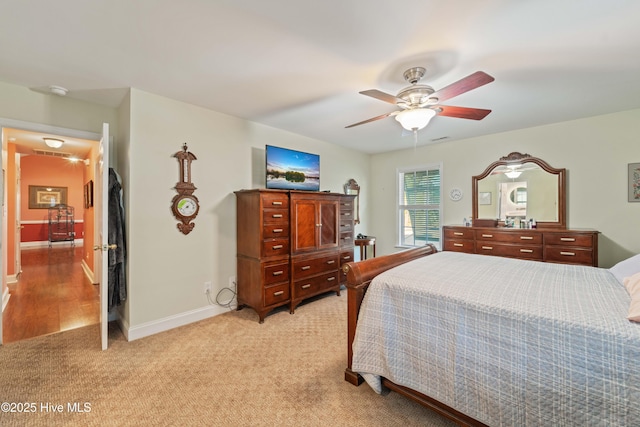 bedroom featuring ceiling fan and light carpet