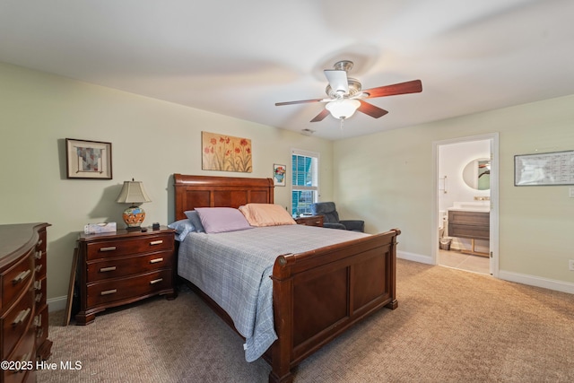 bedroom with light colored carpet, ensuite bath, and ceiling fan