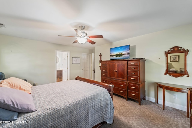 carpeted bedroom featuring ensuite bath and ceiling fan